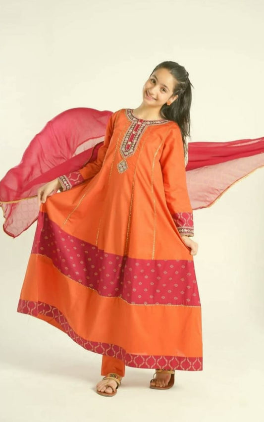 Orange and red traditional outfit with a pink dupatta on a plain background